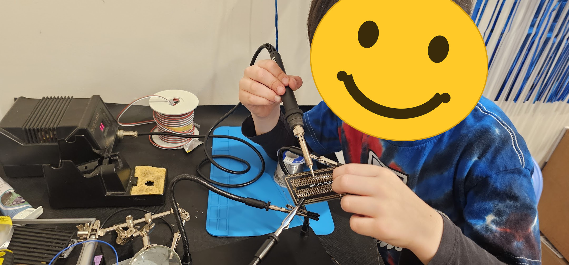 My son soldering the LED matrix connections. His face is covered here on purpose.